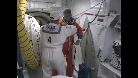 Mission Specialist Michael Good being assisted with launch and entry suit Stock Footage 283460448