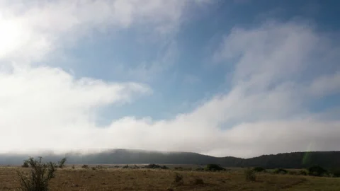 Mist and Clouds Clearing Over Mountian and Plains Stock Footage 153333040