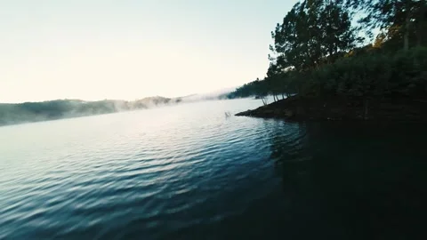 Mist clings to calm lake surface at Castelo de Bode Stock Footage 342266444