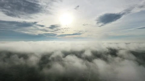 Mist-covered aerial view above clouds with soft sunlight breaking through Stock Footage 332522166