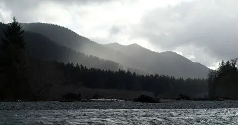 Mist covered mountains over river Stock Footage 125565410