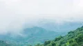 Mist covering mountain peaks. Global warming, climate change. Weather forecast 4k or 4k+ Resolution