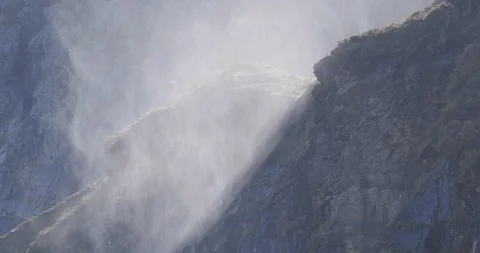 Mist dances in sunlight from waterfall Stock Footage 119553969