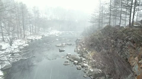 Mist Drifting Across Snow Lined River in Arxan, China Stock Footage 344036182