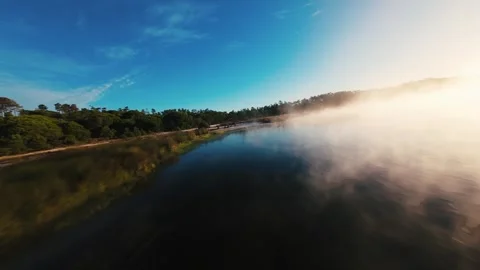 Mist drifts over calm river surface Stock Footage 340903861