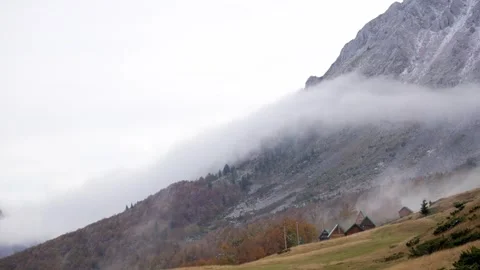 Mist engulfs a rugged mountain. Stock Footage 254525800