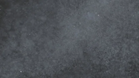 Mist of falling snow particles isolated on black background Stock Footage