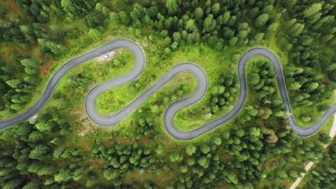 Mist falls on winding Snake Road with car on Giau Pass Stock Footage 232786514