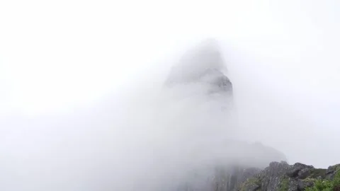Mist flowing over huge mountain Segla in Norway Video stock 244115489