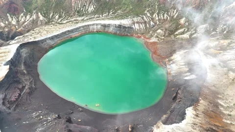 Mist Flowing Over Okama Crater Lake | Japan - 4K Aerial Video Stock Footage 329051311