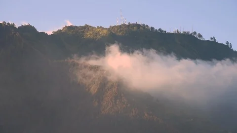 Mist flowing through trees and mountain near Mount Bromo, Indonesia Stock Footage 85582604