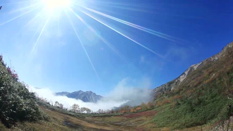 Mist, Hakuba Mountain, the Three Peaks of Hakuba, and the Autumn Foliage Forest Stock Footage 324910280