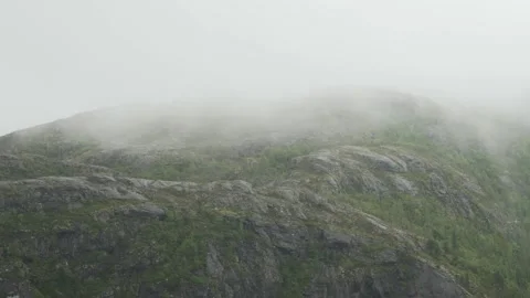 Mist moving through the steep mountains in Norway Stock Footage 237440702