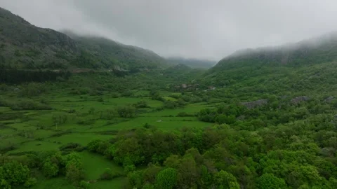 Mist or low clouds float over the mountain hill Stock Footage 249999173