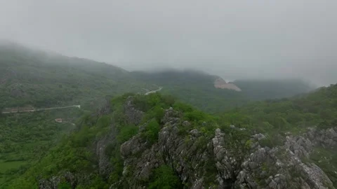 Mist or low clouds float over the mountain hill Stock Footage 249999248