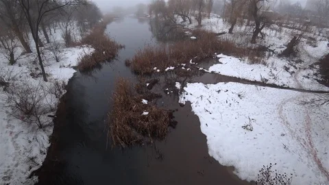 Mist over the current river in the park, snow, thaw, springtime. Video stock 102045769