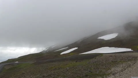Mist Over Mountain Slopes with Patchy Snow in the Icelandic Highlands Video stock 339891319