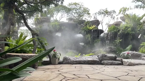 Mist over small waterfall. Backyard garden waterfall with Mist. Stock Footage 253962760