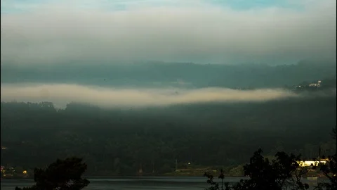 The mist rises from the forest above the lake,time lapse, Portugal Stock Footage 120367410