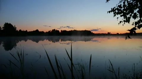 Mist rises over lake Stock Footage 52078511