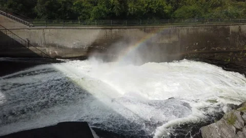 Mist rising over raging river with a rainbow Stock Footage 138650759