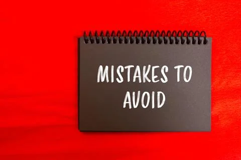 Mistakes to avoid message written on black notebook page with red background. Stock Photos