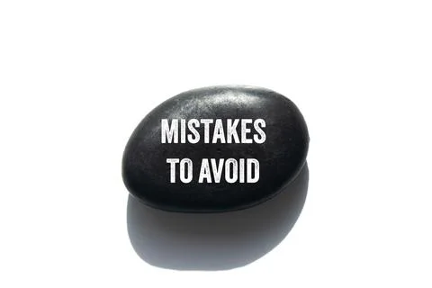 Mistakes to avoid message written on black stone on white background. Conce.. Foto stock