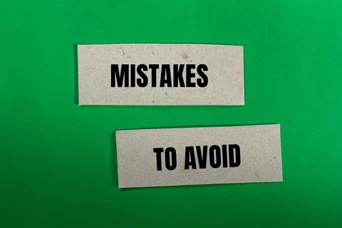 Mistakes to avoid message written on paper pieces with green background. Conc Foto stock