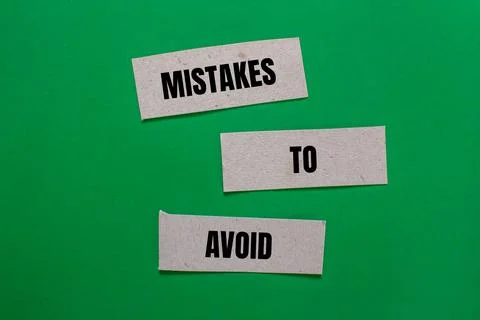 Mistakes to avoid message written on paper pieces with green background. Conc 写真素材