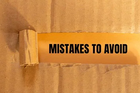 Mistakes to avoid message written on ripped paper with color background. Conc 写真素材