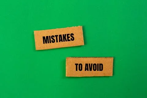 Mistakes to avoid message written on ripped cardboard paper pieces with green Foto stock