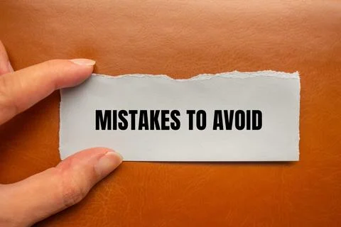 Mistakes to avoid message written on ripped paper piece with brown background 写真素材