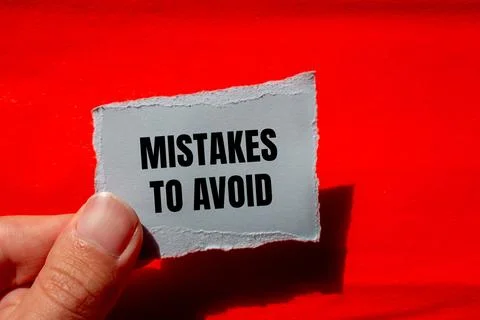 Mistakes to avoid message written on ripped paper piece with red background.  Stock Photos