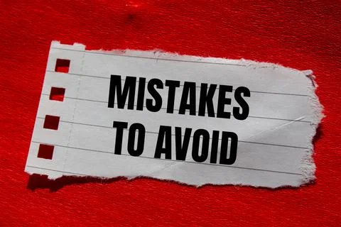 Mistakes to avoid message written on ripped torn paper piece with red backg.. 写真素材