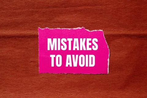 Mistakes to avoid message written on ripped pink torn paper piece with brow.. 写真素材