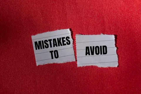 Mistakes to avoid message written on ripped torn paper piece with red backg.. 写真素材