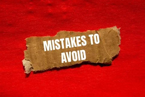 Mistakes to avoid message written on ripped torn cardbaord paper piece with.. Foto stock