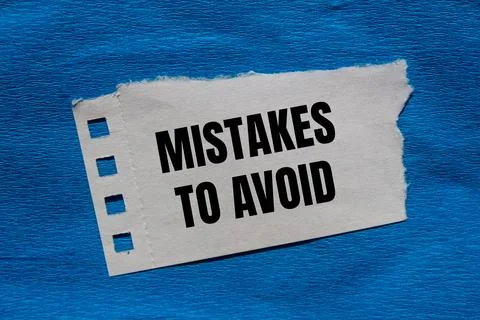 Mistakes to avoid message written on ripped torn paper piece with blue back.. Foto stock
