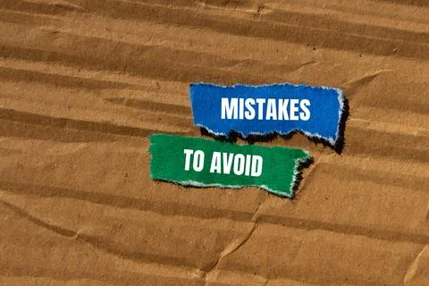 Mistakes to avoid message written on ripped torn paper pieces with cardboar.. Foto stock