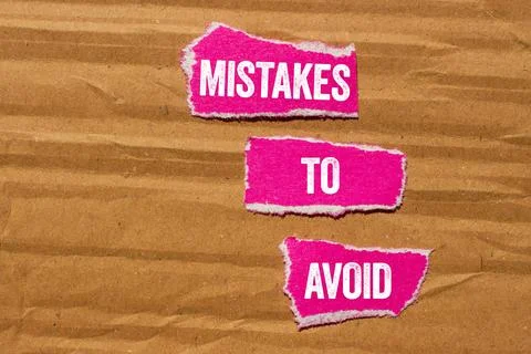 Mistakes to avoid message written on ripped torn pink paper pieces on yello.. Foto stock