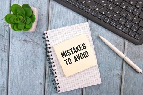 Mistakes To Avoid open notepad with text. bright stickers point to text. Stock Photos