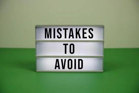 Mistakes To Avoid text on light box on green background 写真素材