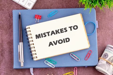 MISTAKES TO AVOID, text in the notebook. View from above Stock Photos