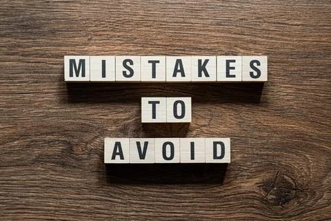 Mistakes to avoid - word concept on building blocks, text Stock Photos