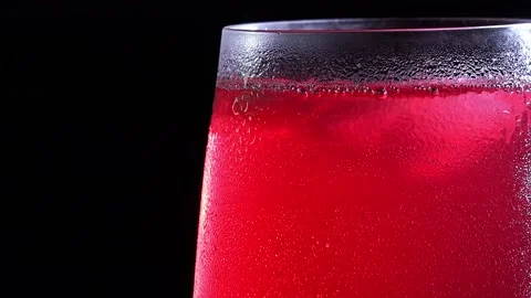 A misted glass with a drink and bubbles in close-up. Cold drink with ice Stock Footage 217405459