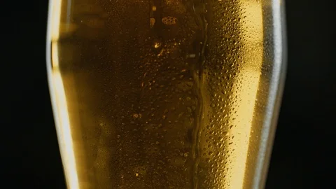 Misted mug of cold light kraft beer, drops flow down the glass, in bar or pub Stock Footage 94585349
