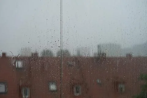 Misted window with flowing down water drops. Water drops on the glass Stock Photos