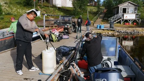Mistissini, Quebec/Canada - 08 14 2017: Cree refuel fishing boat at camp Stock Footage 125636790