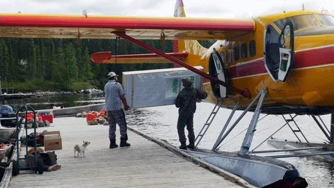 Mistissini, Quebec/Canada - 08 14 2017: Cree unload seaplane at camp Stock Footage 125636817