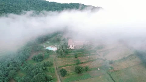 Mistshrouded countryside with tranquil accommodation. Peaceful rural lodge Stock Footage 343181690